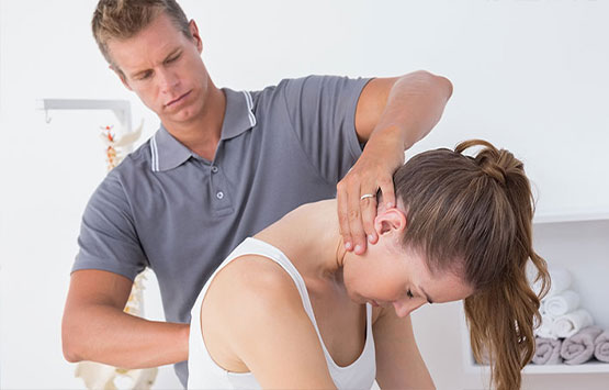 Chiroprator at Center For Auto Accident Injury Treatment in San Diego adjusting female patient's neck to relieve whiplash effects