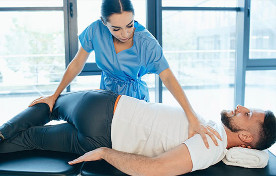 Male patient receiving chiropractic treatment for sciatica at Center For Auto Accident Injury Treatment in San Diego