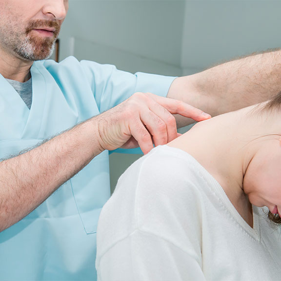 Patient receiving chiropractic consultation for whiplash at Center For Auto Accident Injury Treatment in San Diego