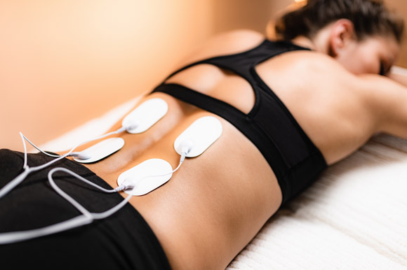 Woman doing Electrical Muscle Stimulation
		  at Center For Auto Accident Injury Treatment in San Diego after an auto accident resulting in whiplash